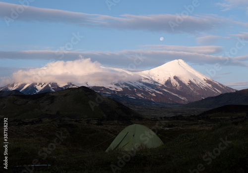 Tent against the background of Klyuchevskoy volcano, Kamchatka