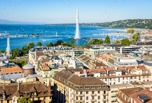 Aerial view over the rooftops of the Geneva, Switzerland, the bay of Geneva and the Lake Geneva from the bell tower of Saint-Pierre cathedral on a sunny summer day.