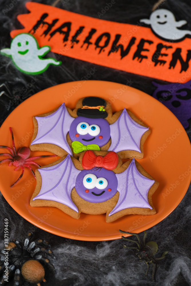 A couple (girl and boy) of funny, amusing bat painted on honey gingerbread. Halloween food. A couple (girl and boy) of funny, amusing bat painted on honey gingerbread. Halloween food.