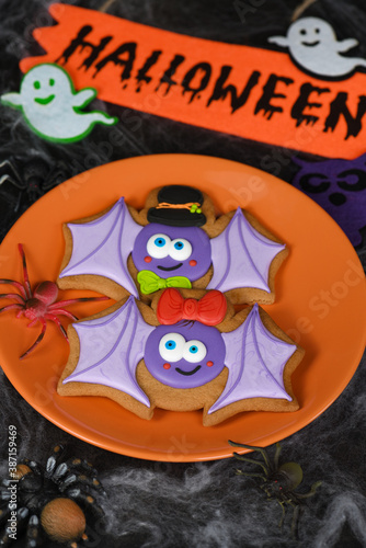 A couple (girl and boy) of funny, amusing bat painted on honey gingerbread. Halloween food.