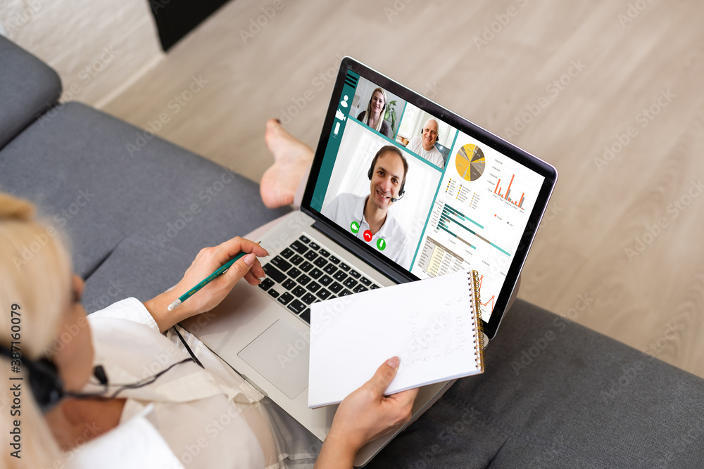 Back view of business woman talking to her colleagues about plan in video conference. Multiethnic business team using laptop for a online meeting in video call. Group of people smart working from home Back view of business woman talking to her colleagues about plan in video conference. Multiethnic business team using laptop for a online meeting in video call. Group of people smart working from home