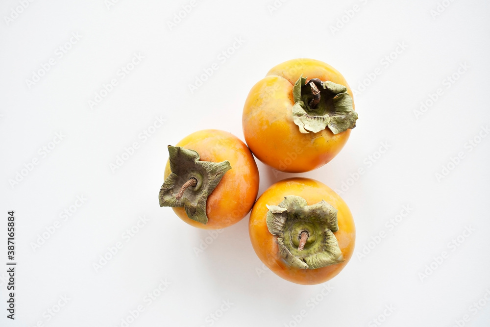 Ripe persimmon on a white background. Top view.