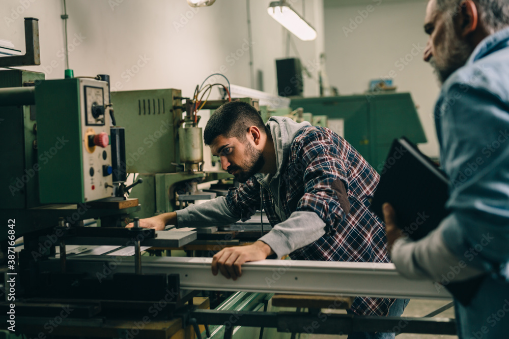 Aluminium and PVC industry worker making PVC frames for windows Aluminium and PVC industry worker making PVC frames for windows