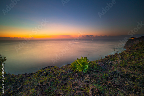 Seascape. Spectacular view from Uluwatu cliff in Bali. Sunset time. Blue hour. Ocean view. Colorful sky. Nature concept. Soft focus. Slow shutter speed.