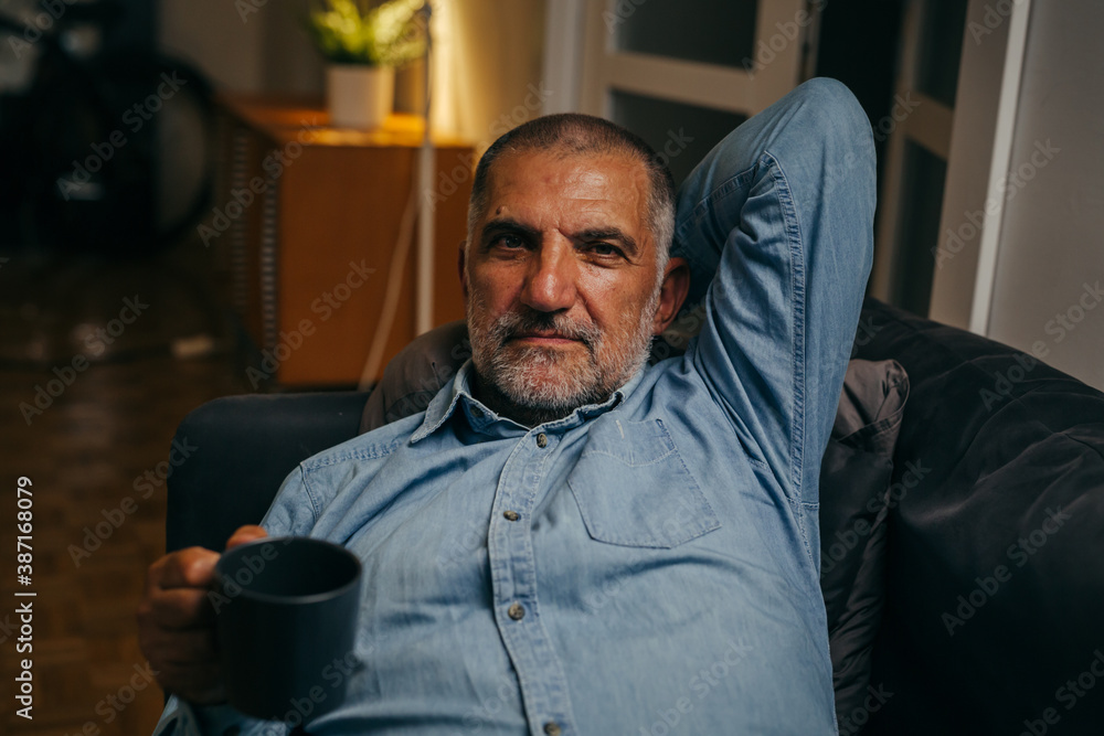 senior man having relaxing on sofa at home senior man having relaxing on sofa at home