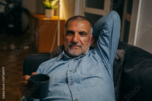 senior man having relaxing on sofa at home © cherryandbees