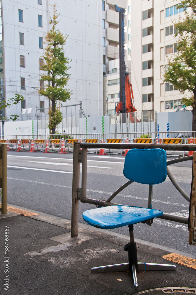 Abandoned simple blue office chair on a street alone in the morning Abandoned simple blue office chair on a street alone in the morning