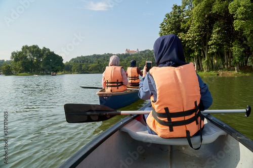 Muslim women kayaking at the lake