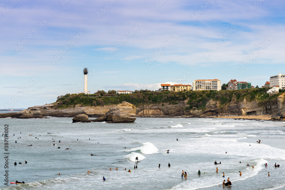 many surfers enjoy the waves on the Grand Plage in Biarritz