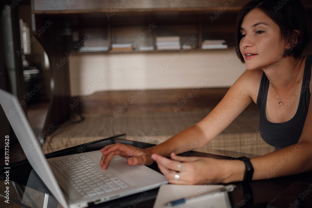 Young female student using laptop, communicates on internet with teachers. Young female student using laptop, communicates on internet with teachers.