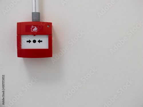 Modern fire alarm detail, white wall