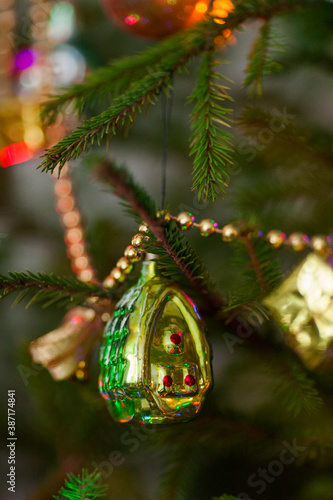 Classic traditional holiday toys on a real live green Christmas tree © Timur Abasov