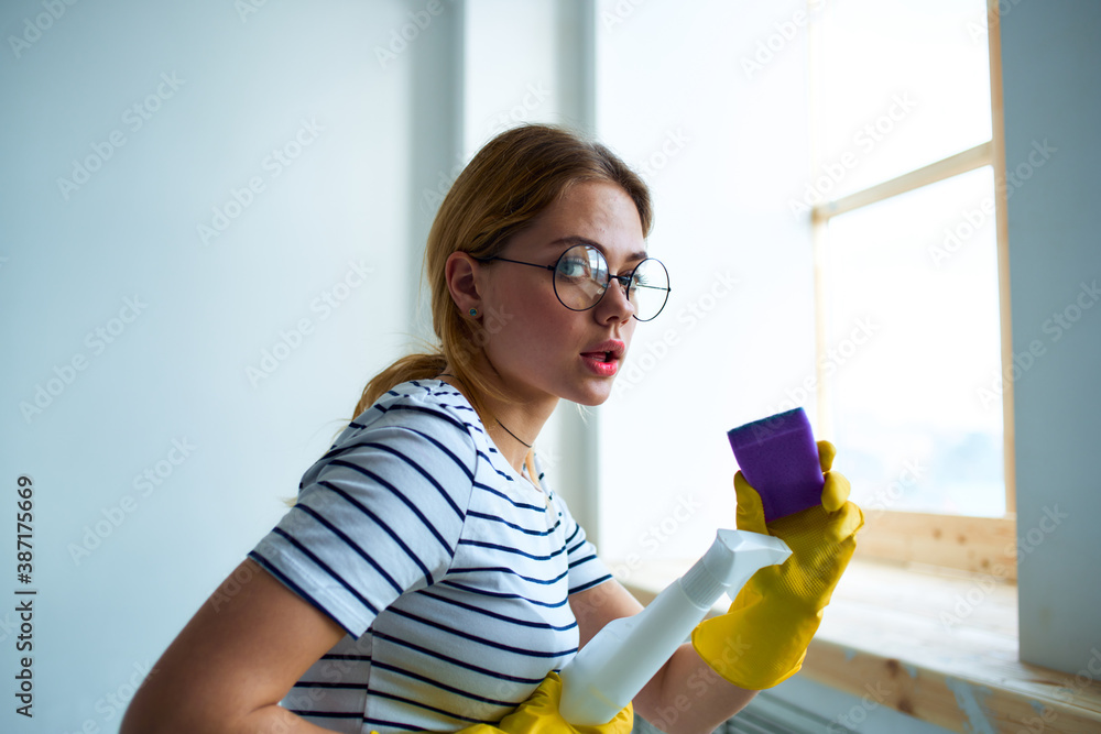 cleaning lady with a sponge in her hands home care service detergent window cleaning cleaning lady with a sponge in her hands home care service detergent window cleaning