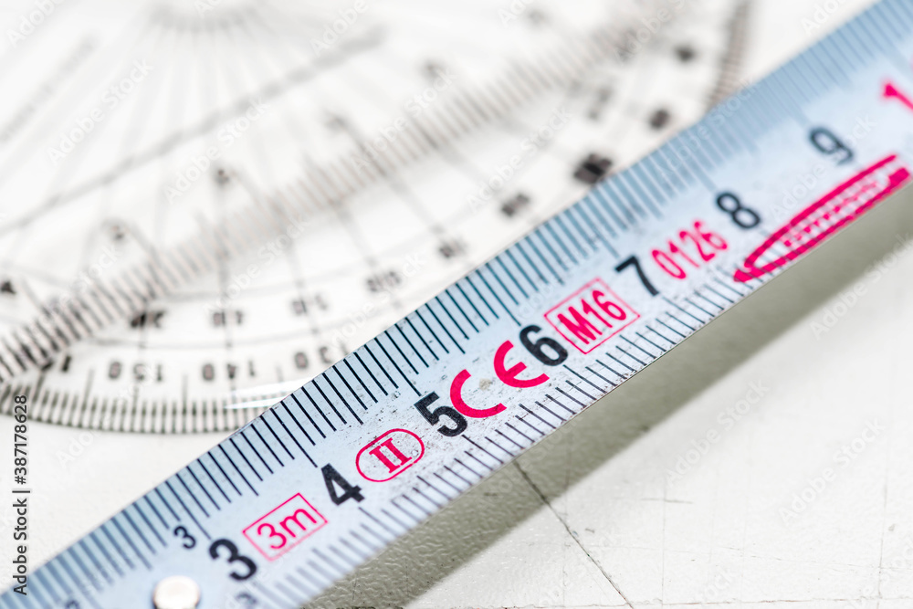 Tape measurer, geometrical rulers close up macro shot on scratched wooden material. Tape measurer, geometrical rulers close up macro shot on scratched wooden material.