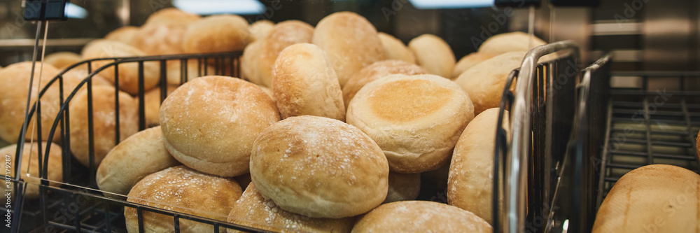 Freshly baked bread on bakery shelves.