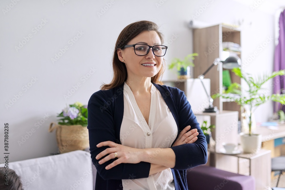 Portrait of positive confident middle aged woman with arms crossed Portrait of positive confident middle aged woman with arms crossed
