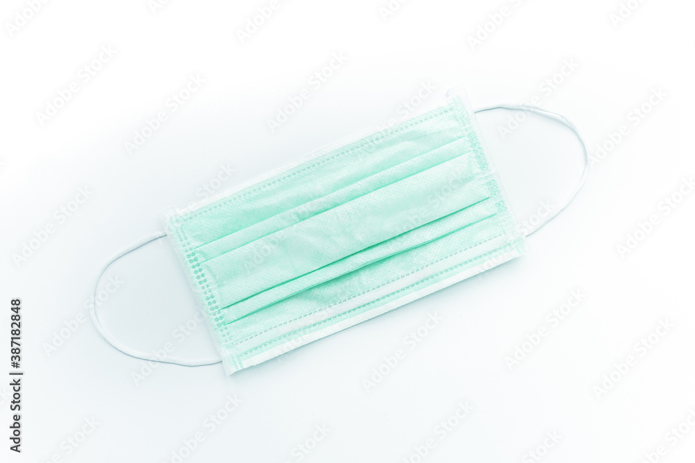 Surgical mask isolated on white background.Concept : Medical waste disposal during the novel COVID-19 pandemic. Surgical mask isolated on white background.Concept : Medical waste disposal during the novel COVID-19 pandemic.