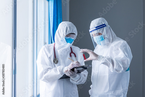Two doctor holding blood sample test tube on white background. concept of Coronavirus or COVID-19 outbreak, Concept of finding ways to prevent the spread of coronavirus.