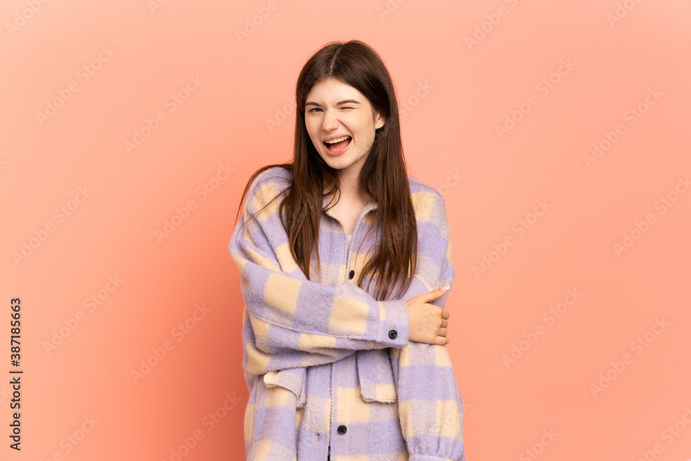 Fototapeta premium Young Ukrainian girl isolated on pink background laughing
