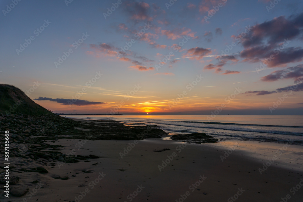 Obraz premium sunset on the Atlantic coast of France on the Ile de with the Baleines Lighthouse behind