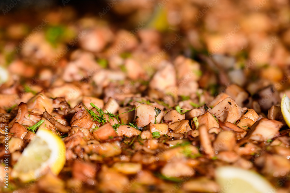 Large group of cooked mussels with tomato and cream sauce at a street food festival, ready to eat seafood, beautiful orange monochrome outdoor background. Large group of cooked mussels with tomato and cream sauce at a street food festival, ready to eat seafood, beautiful orange monochrome outdoor background.