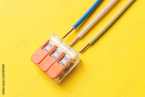 Compact splicing connector with connected wire. phase, zero, ground. photo