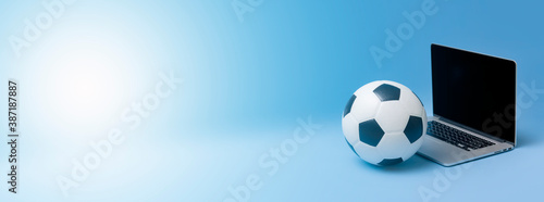 Fototapeta Naklejka Na Ścianę i Meble -  Laptop With Soccer Football Ball On Blue color background. Workout online concept