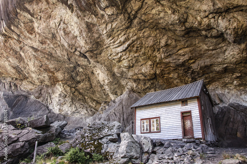 Historical hut in Helleren, Norway. Built of wood, they stand for several hundred years under a huge rock overhang. © Ungrim