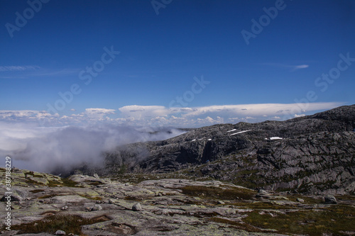 Rocky landscape of mountains above the clouds. Views from the trail to Mount Kjerag
