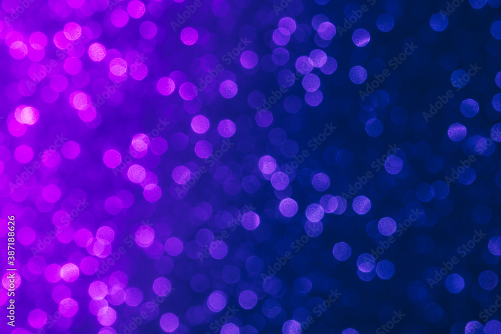 Abstract purple and blue color dots defocused bokeh background. Holiday festive concept. 