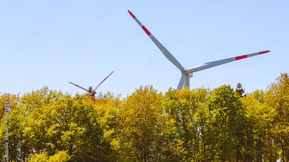 wind turbines behind trees wind turbines behind trees