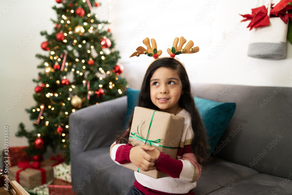 Girl trying to guess what her gift is Girl trying to guess what her gift is