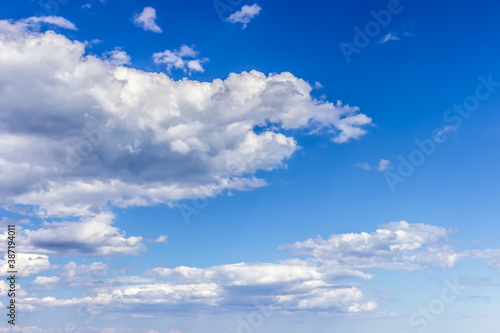 Blue sky background with fluffy clouds