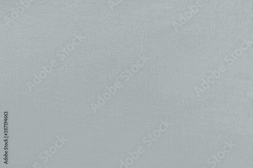 Gray homogeneous background with a textured surface, fabric.