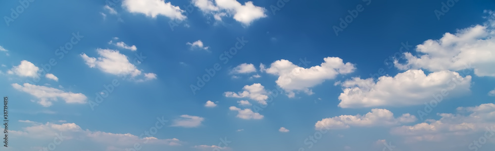 Fototapeta premium Blue sky background with fluffy clouds