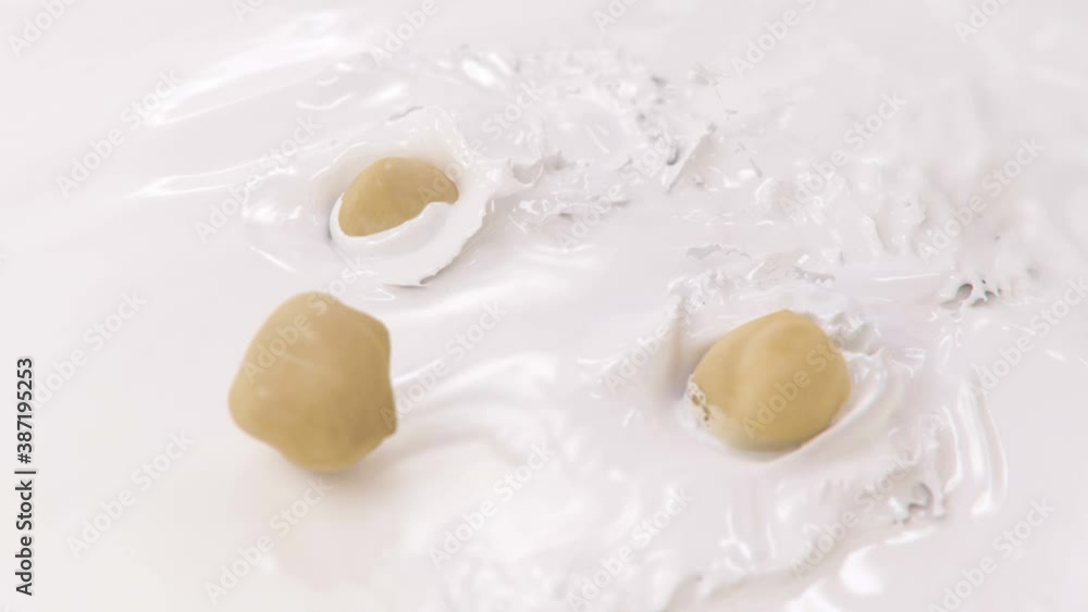 Hazelnuts Falling Into Milk in 4K Super slow motion Hazelnuts Falling Into Milk in 4K Super slow motion
