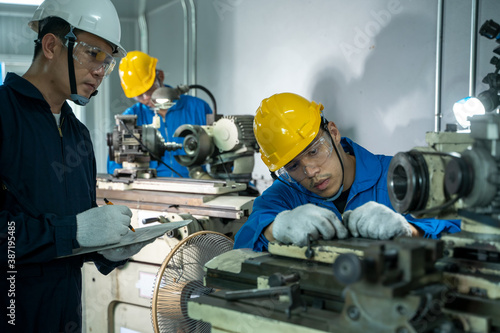 Mechanic working in the factory,The industrial worker team is working at a industrial factory.