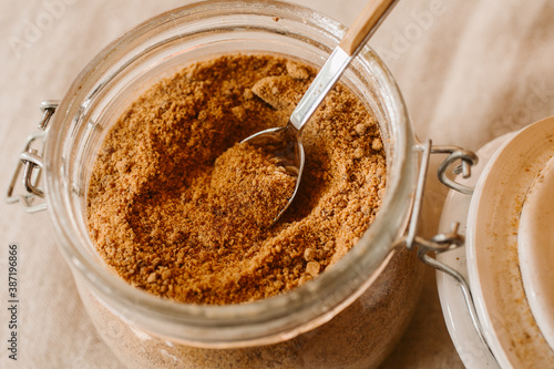 Panela sugar background. Close up view of raw cane sugar in a jar.	