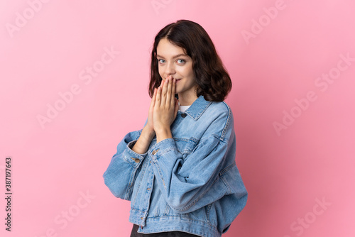 Teenager Ukrainian girl isolated on pink background keeps palm together. Person asks for something