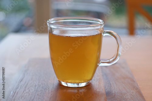 Organic Lemon Green tea in Transparent cup at table near window