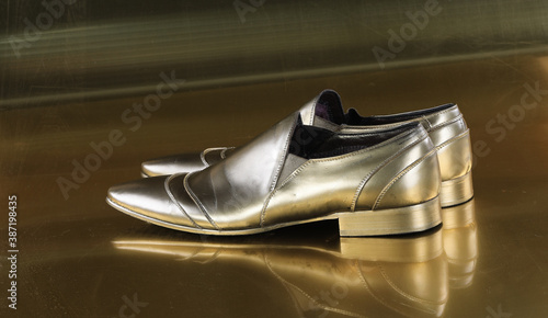 gold men's shoes on a gold background