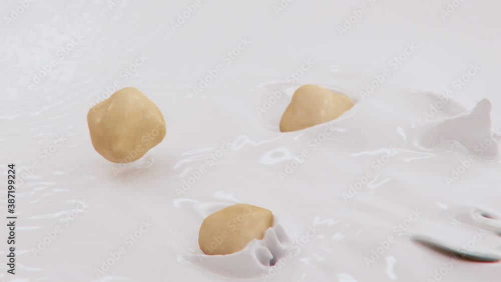 Hazelnuts Splashing Into Liquid Cream in 4K Super slow motion Hazelnuts Splashing Into Liquid Cream in 4K Super slow motion