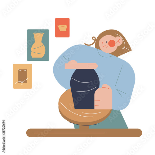 Smiling girl artist sitting and making clay jug on potters wheel