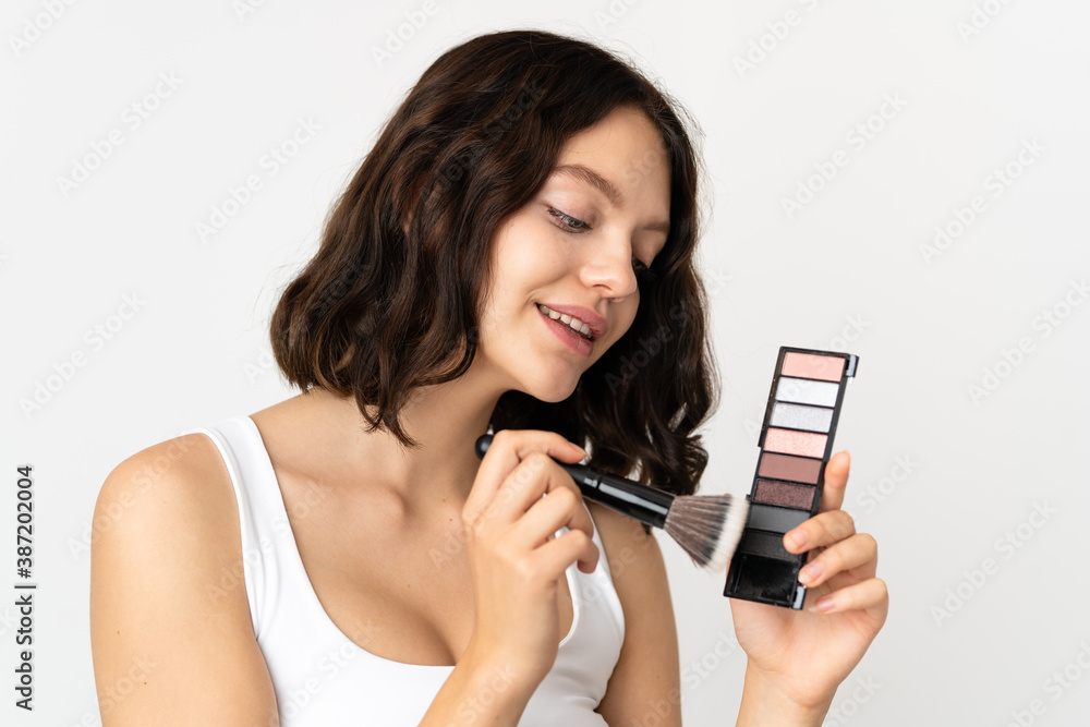 Teenager Ukrainian girl isolated on white background with makeup palette Teenager Ukrainian girl isolated on white background with makeup palette