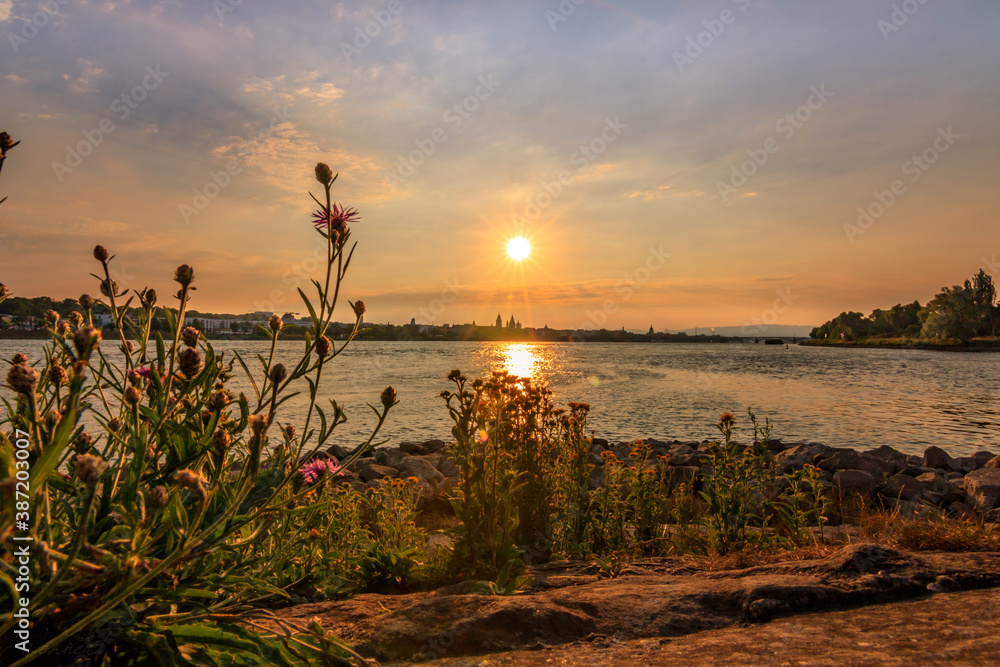 sunset on the sea. beautiful sunset over the rhine near mainz and Wiesbaden. this orange sunset over a river is really picturesque and shows stones in the foreground sunset on the sea. beautiful sunset over the rhine near mainz and Wiesbaden. this orange sunset over a river is really picturesque and shows stones in the foreground