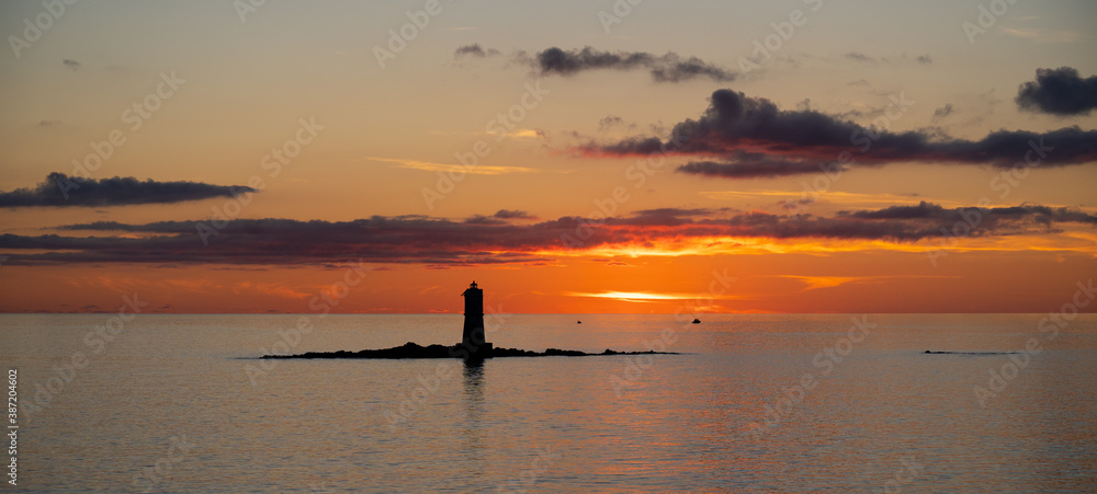 the lighthouse of the Mangiabarche on a serene sunset,autumn day
