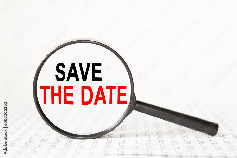 text SAVE THE DATE in a magnifying glass, office concept, business concept, Finance text SAVE THE DATE in a magnifying glass, office concept, business concept, Finance
