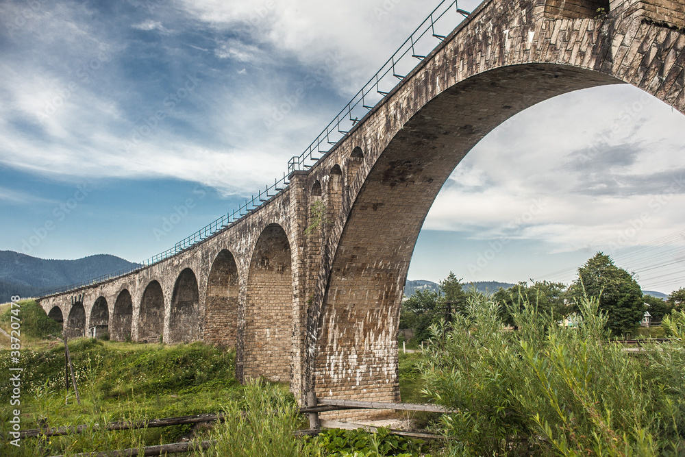 Fototapeta premium landscape, old railway bridge on a background of mountains