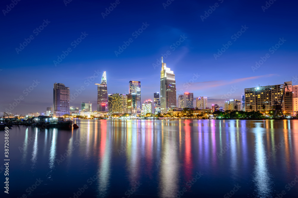 View of Hochiminh city at night from the banks of the Saigon River. Ho Chi Minh City, Vietnam.