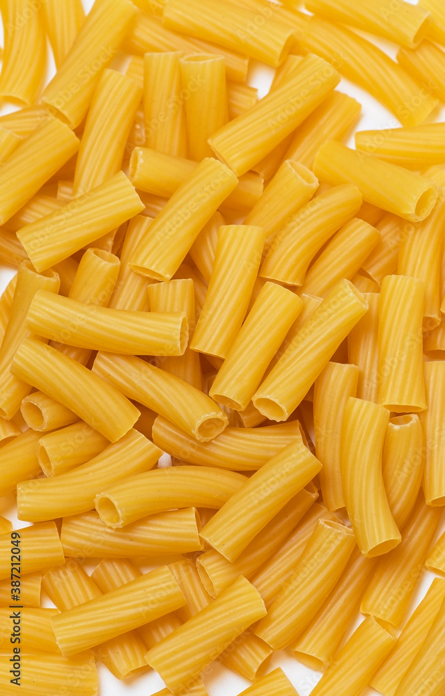 raw pasta close-up on white plate, upright position (italian pasta) raw pasta close-up on white plate, upright position (italian pasta)